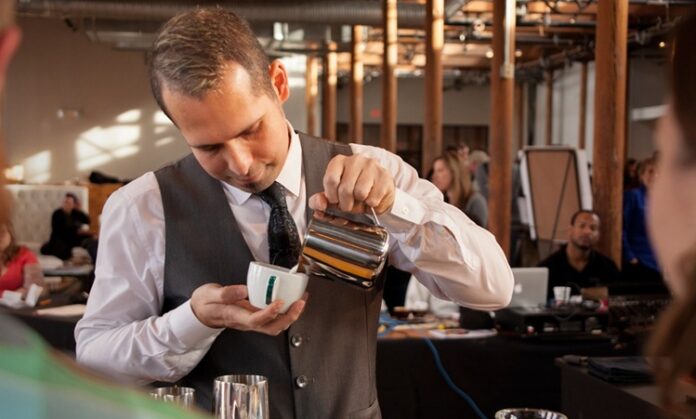 Başarılı Bir Baristanın Özellikleri Nelerdir Kahve kültürünün hızla gelişmesiyle birlikte barista mesleği de son yılların en çok ilgi gören profesyonel alanlarından biri haline geldi. Günümüzde bir barista, yalnızca kahve hazırlayan kişi olarak görülmüyor. Aynı zamanda kaliteli hizmet sunan, kahve bilgisine hâkim olan, müşteri deneyimini geliştiren ve işletmenin marka değerine katkı sağlayan önemli bir profesyonel olarak değerlendiriliyor. Konulu bir haber görseli.